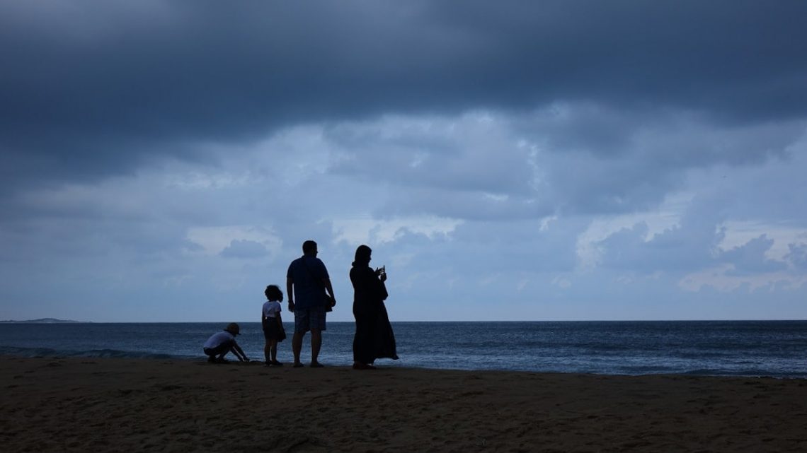 a family standing on a beach
