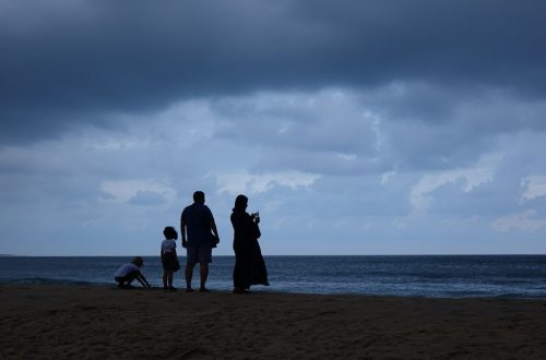 a family standing on a beach