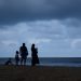 a family standing on a beach