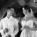 A bride and groom holding candles in a traditional romantic wedding ceremony setting.